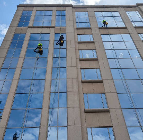 professionals on high rise building performing maintenance work